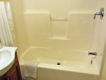 Shower tub with bath mat, shower curtain, vanity unit