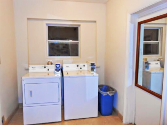 Coin operated washer and dryer, waste bin, mirror, tiled flooring