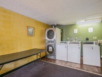 Coin operated washers and dryers, table for folding laundry, carpet flooring