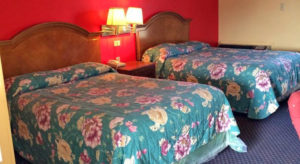 Two queen beds, night stna dwith telephone, wall mounted bedside lights, carpet flooring