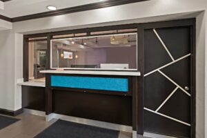 Guest check in desk with regular and lower height desks, tiled flooring