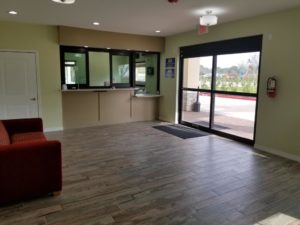 Guest check in desk, sofa, laminate flooring