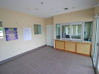 Guest check in desk, protective glass partition, tiled flooring