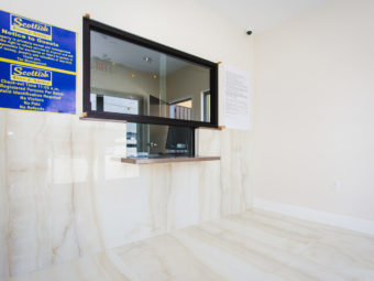 Guest check in desk with glass partition, Guest information notices