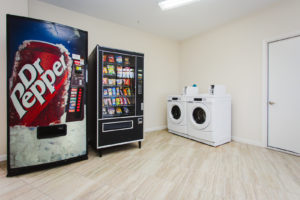 Soda and snacks vending machines, coin operated washer and dryer, tiled flooring