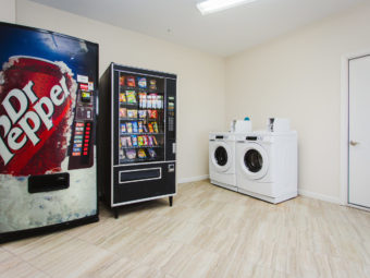 Soda and snacks vending machines, coin operated washer and dryer, tiled flooring