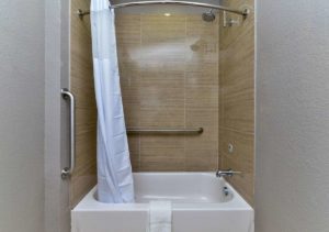Shower tub with shower curtain and grab rails