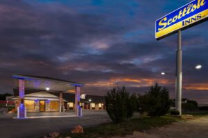 Brand signage, drive through canopy, hotel entrance, night time lighting, external entrances to guest rooms, parking spaces