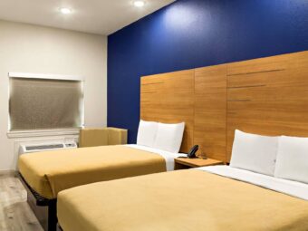 Two queen beds, night stand with telephone, corner seat, laminate flooring
