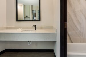 Vanity unit, mirror, doorway to shower tub