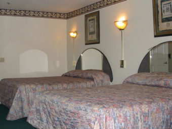 Two double beds, wall mounted bedsid elights and art, mirrored head boards, carpet flooring