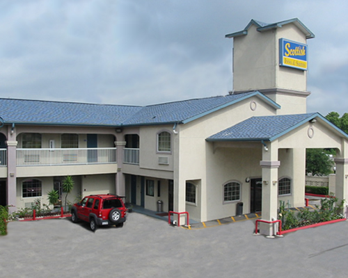 hotel entrance with drive through canopy, two story building with exterior room entrances, parking spaces