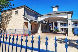 Hotel entrance with drive through canopy, decorative fencing