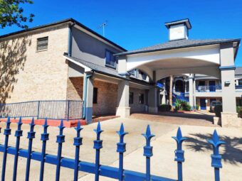 Hotel entrance with drive through canopy, decorative fencing