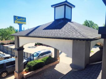 Hotel drive through canopied entrance, brand signage, parking spaces