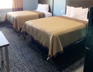 Two queen beds, carpet flooring