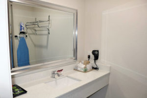 Vanity unit, mirror, ice bucket, hair dryer, wall mounted ironing board and iron