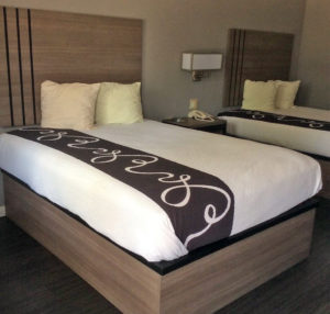 Two queen beds, night stand with telephone, laminate flooring