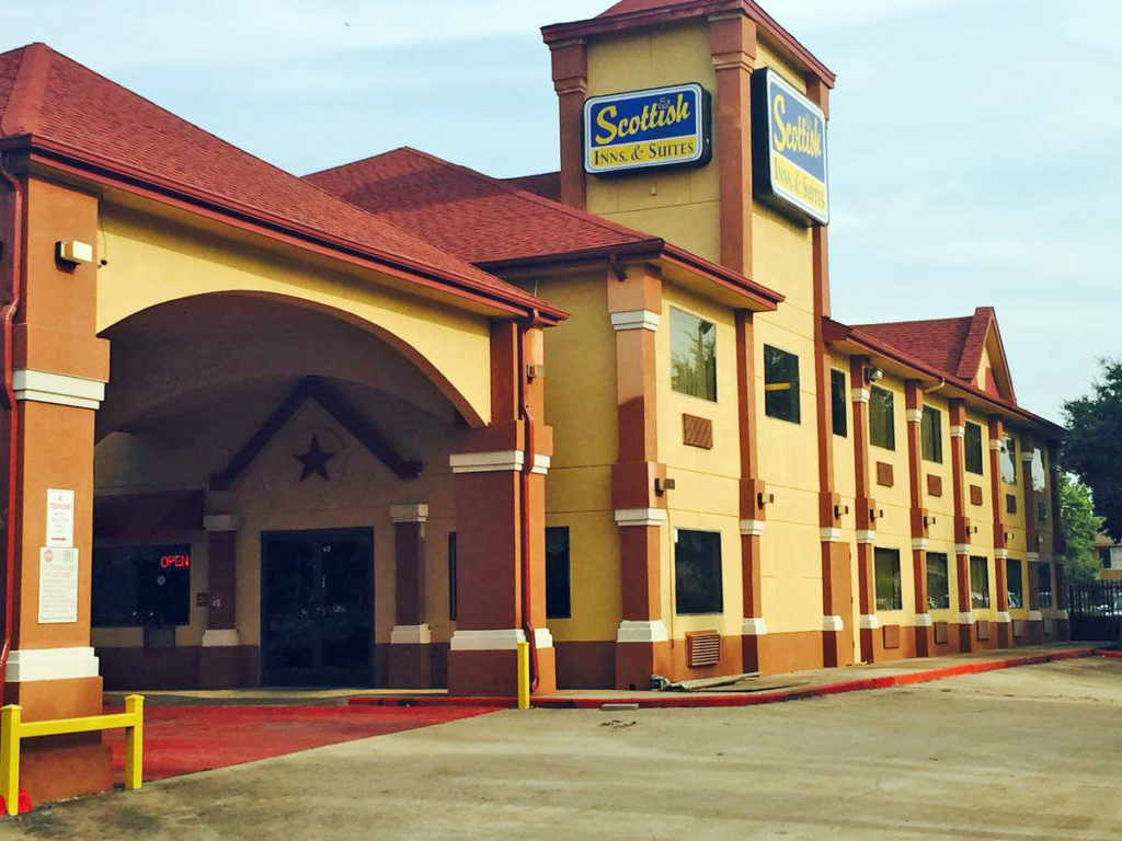 Hotel entrance with canopied drive through, two story building