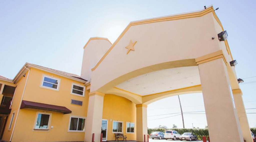 Hotel entrance with drive through canopy, parking spaces