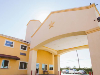 Hotel entrance with drive through canopy, parking spaces