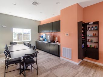 Tables and chairs, snacks and soda selection shelves, breakfast display counter with coffee machine and juice machine