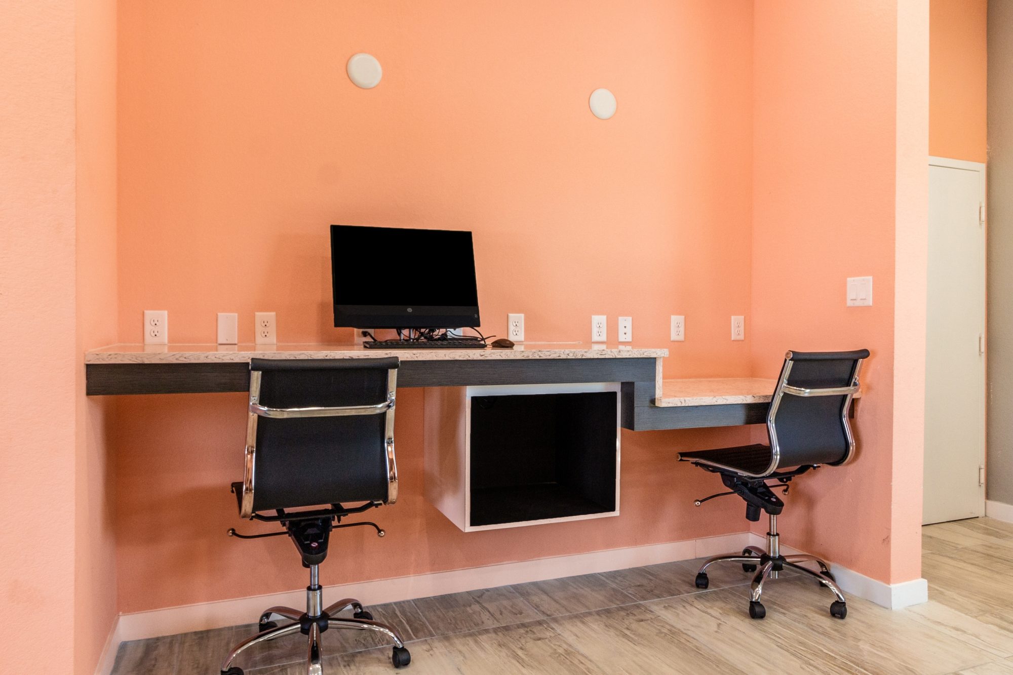 office chairs, monitor, keyboard, wall mounted desk, laminate flooring
