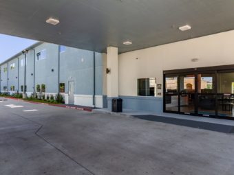 Hotel entrance with canopied drive through, two story building