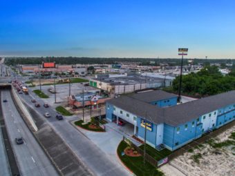 Drone view of hotel exterior, two story building