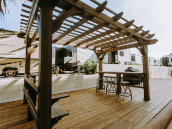 Gazebo with bench seat and bar with bar stools, grill, wooden flooring