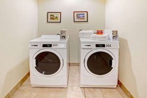Coin operated washer and dryer, art images, tiled flooring
