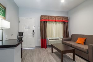 Sofa, coffee table, desk with lamp and office chair, laminate flooring