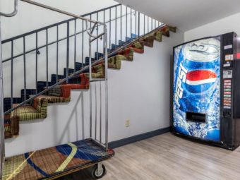 Soda Vending machine, luggage dolly, stairs to upper floor, laminate flooring