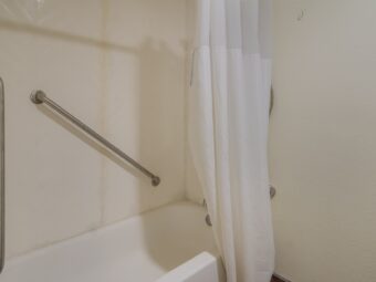Shower tub with grab handles and shower curtain