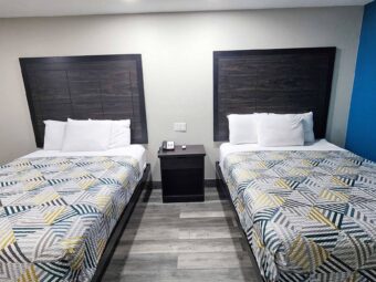 Two queen beds, night stand with telephone, laminate flooring
