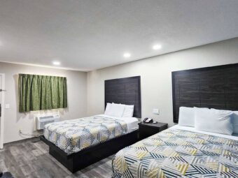 Two queen beds, night stand with telephone, laminate flooring