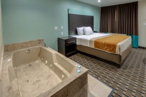 Jacuzzi, king bed, night stands, carpet flooring