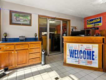 Wooden unit with lamps, guest check in desk, tiled flooring